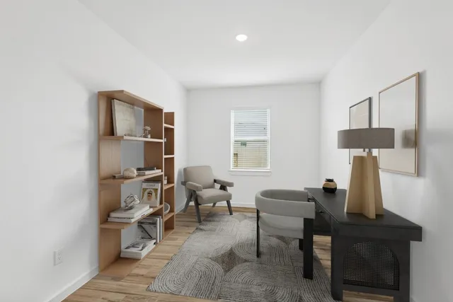 a living room with furniture a piano and a window