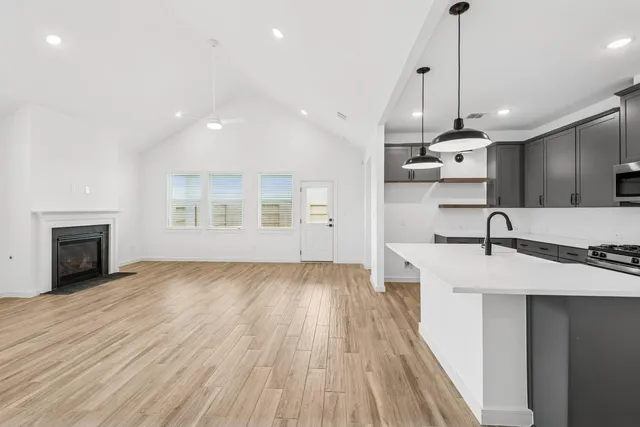 a view of a kitchen with a sink wooden floor and a kitchen counter top space