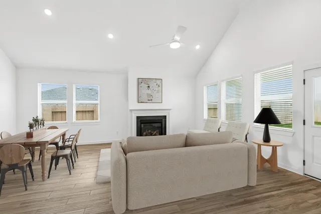 a living room with furniture a fireplace and a table