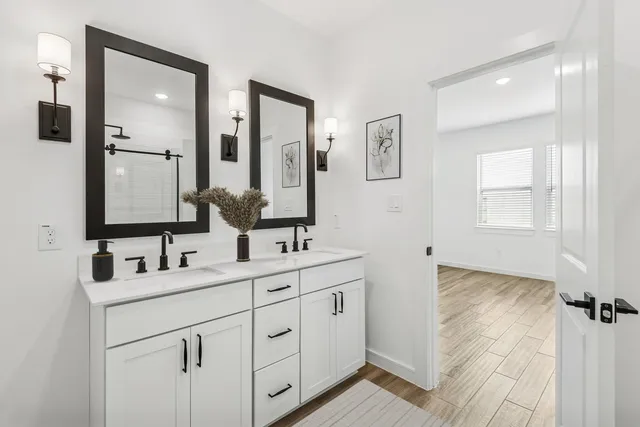 a bathroom with double sink and mirror
