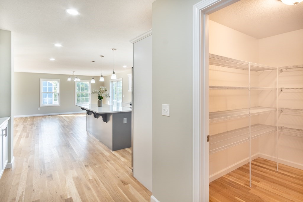 4 Upper Palmer Road Monson, MA 01057 - Photo 11 of 42 a view of a hallway with wooden floor and a bathroom