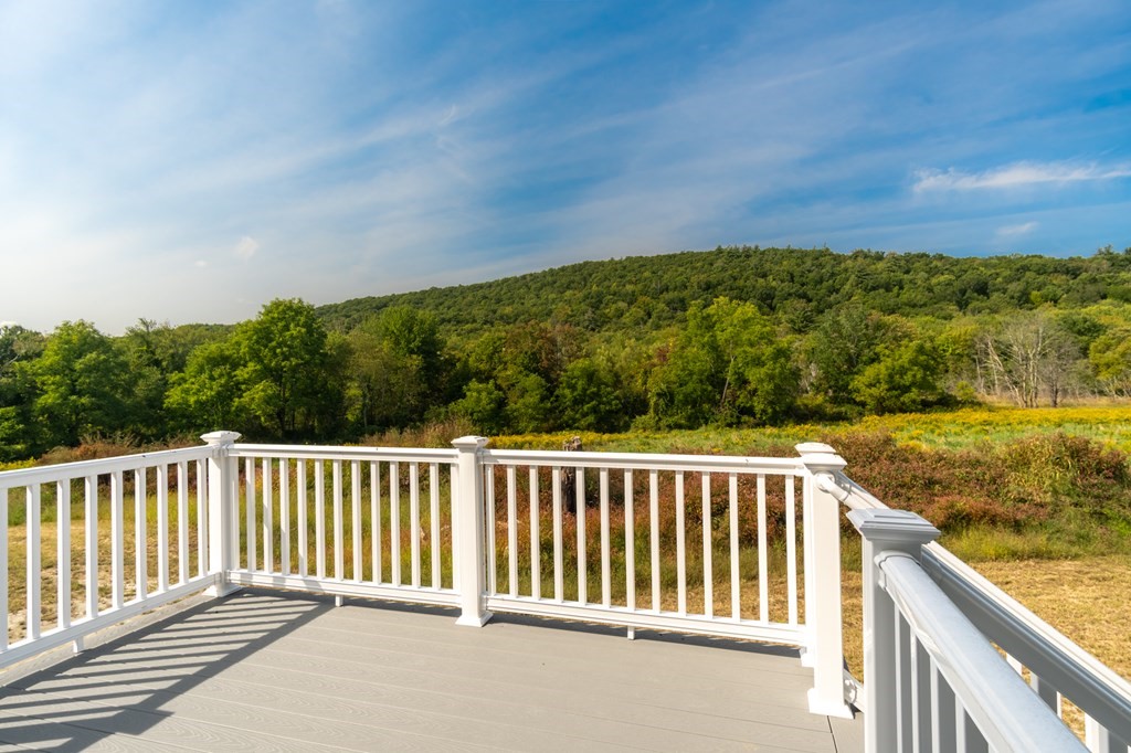 4 Upper Palmer Road Monson, MA 01057 - Photo 31 of 42 a balcony with wooden floor and yard in the back