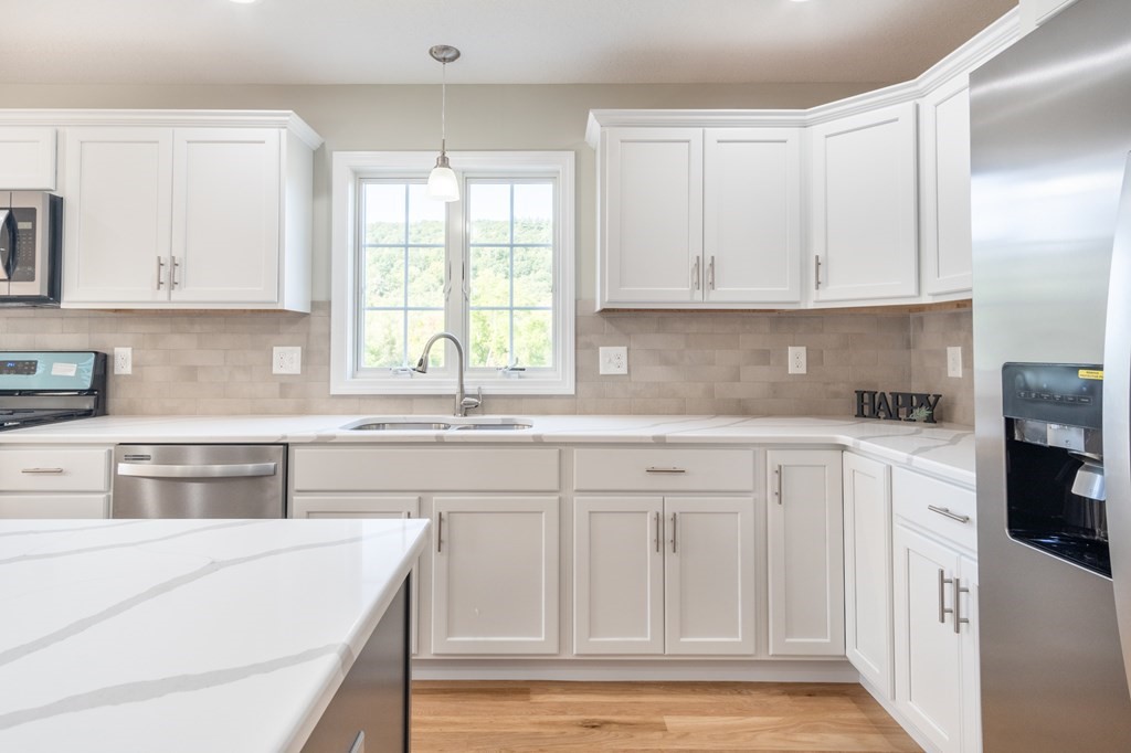4 Upper Palmer Road Monson, MA 01057 - Photo 8 of 42 a kitchen with granite countertop white cabinets white appliances a sink and a window