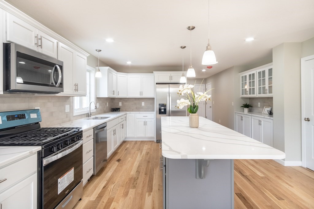 4 Upper Palmer Road Monson, MA 01057 - Photo 9 of 42 a large kitchen with stainless steel appliances kitchen island granite countertop a stove a sink and a microwave