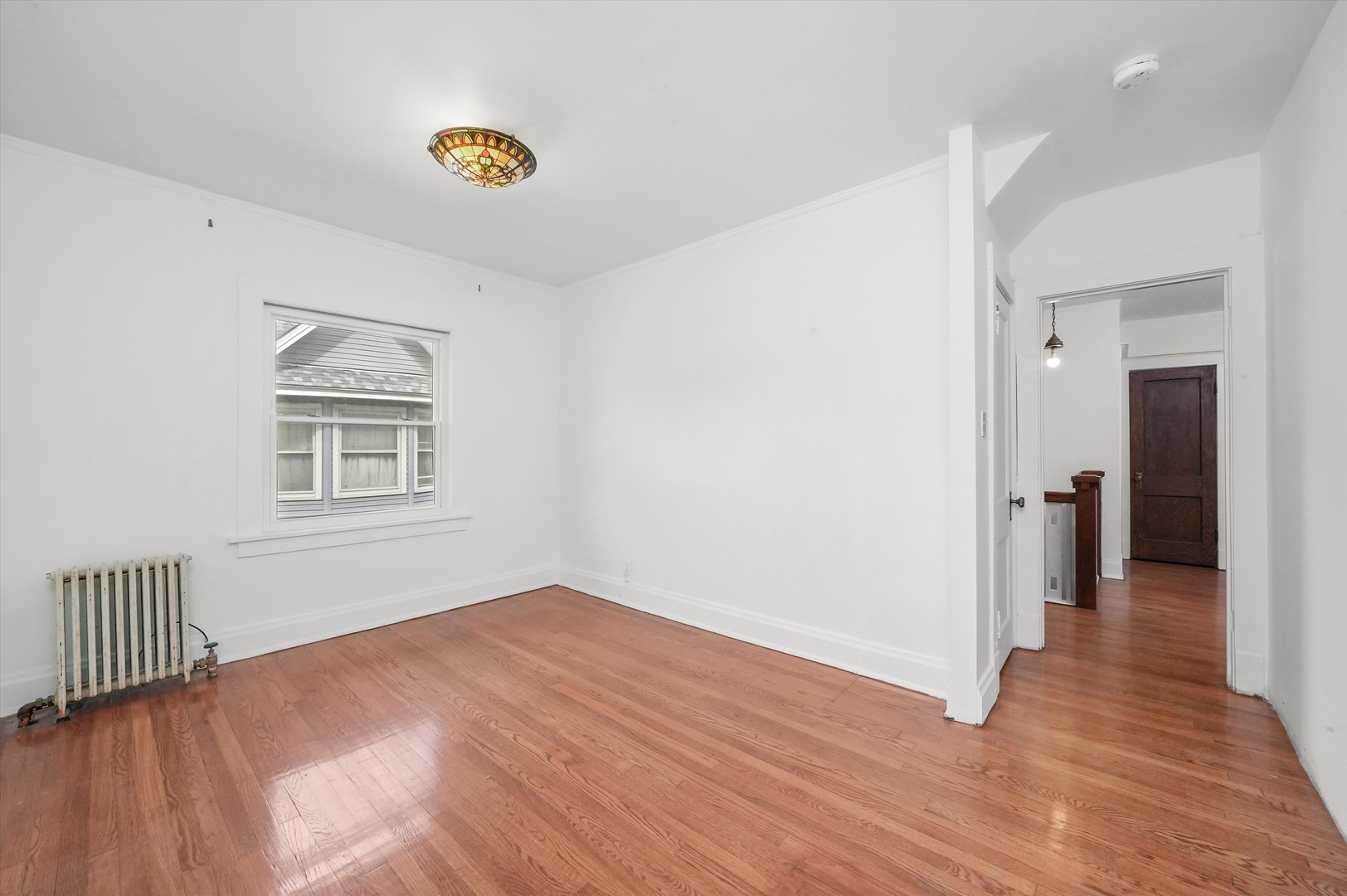 6822 34th Street Berwyn, IL 60402 - Photo 18 of 35 a view of an empty room with wooden floor and a window