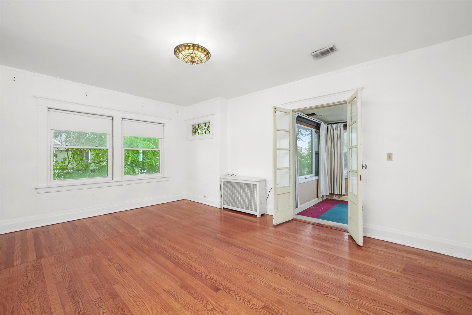 6822 34th Street Berwyn, IL 60402 - Photo 20 of 35 an empty room with wooden floor and windows