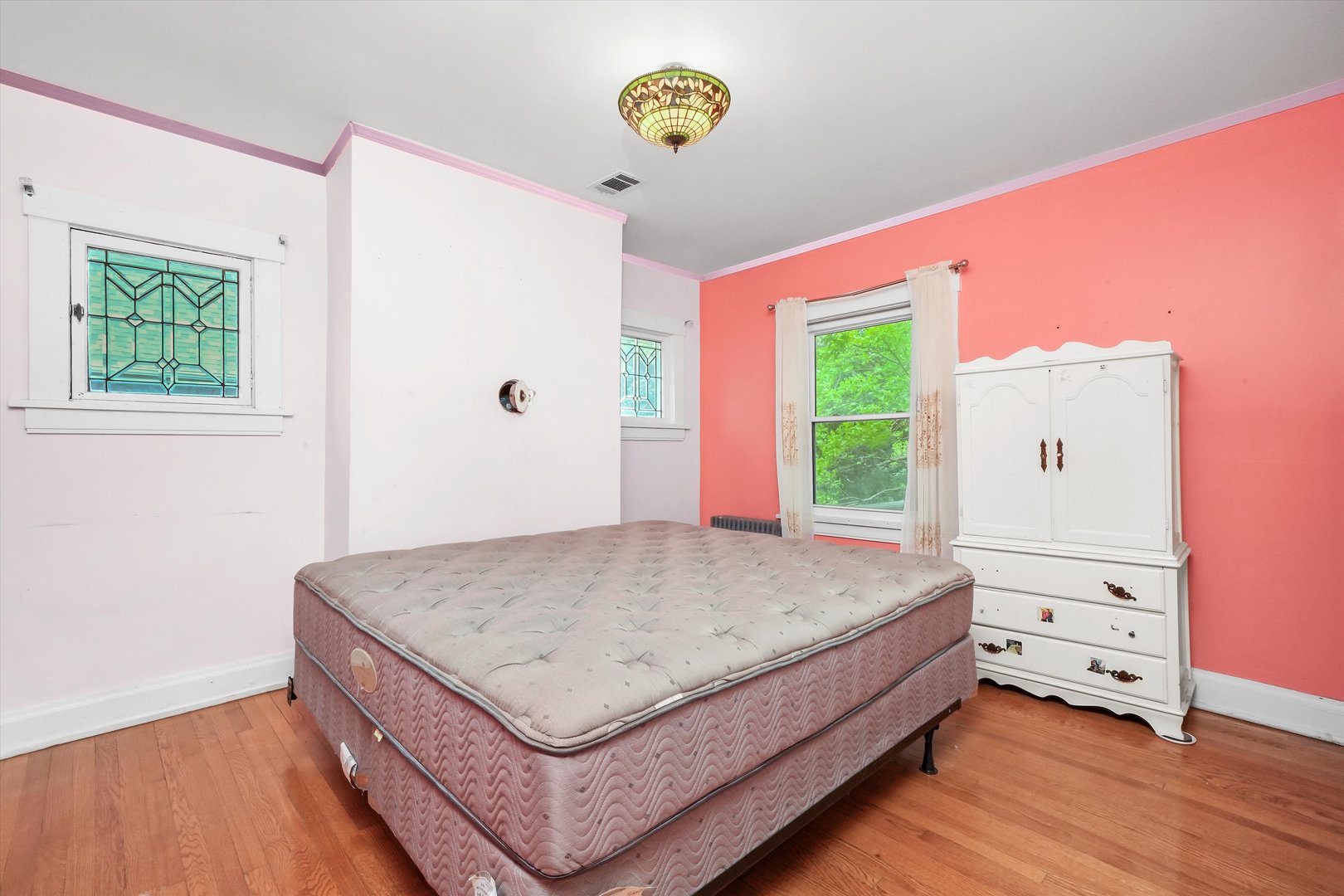 6822 34th Street Berwyn, IL 60402 - Photo 24 of 35 a living room with a bed and a window
