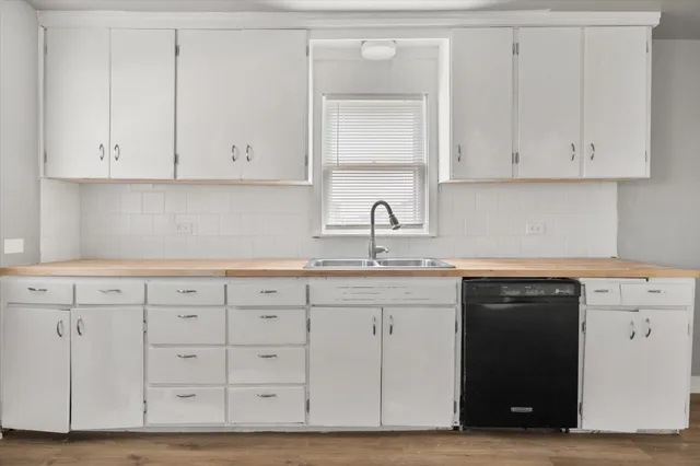 a kitchen with white cabinets