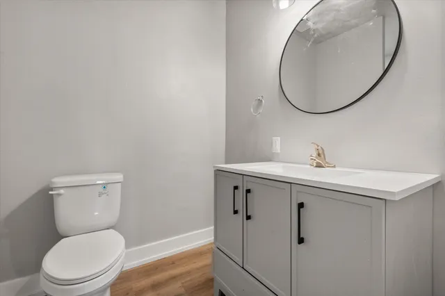 a bathroom with a toilet a sink and mirror