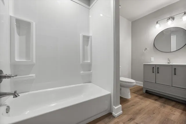 a bathroom with a sink a toilet and vanity