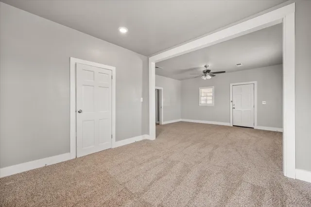an empty room with windows and closet