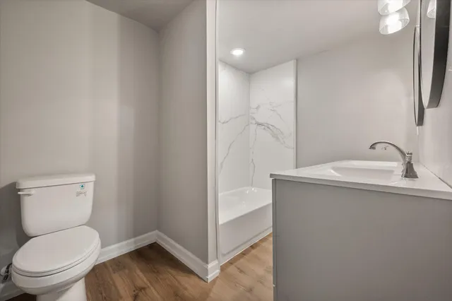 a bathroom with a toilet sink and a mirror
