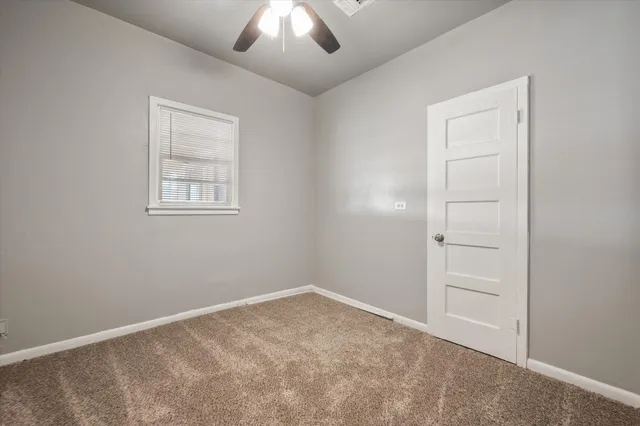 an empty room with windows and closet