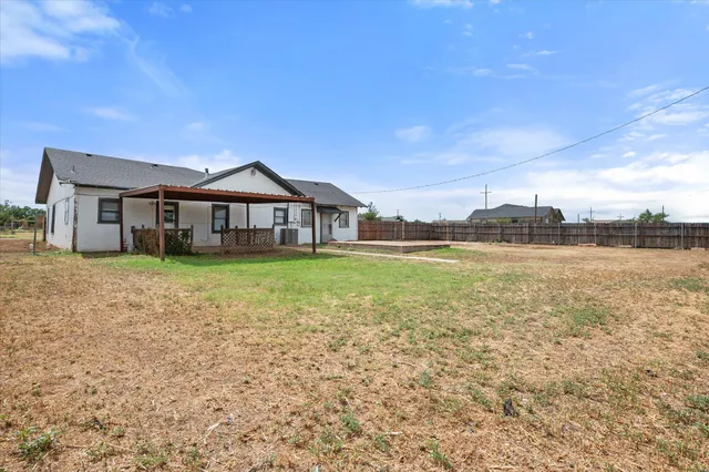 a front view of a house with a garden and lake view