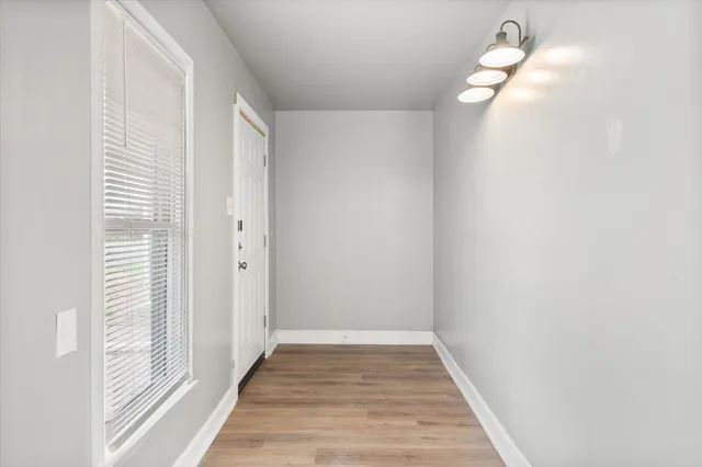 a view of a livingroom and wooden floor