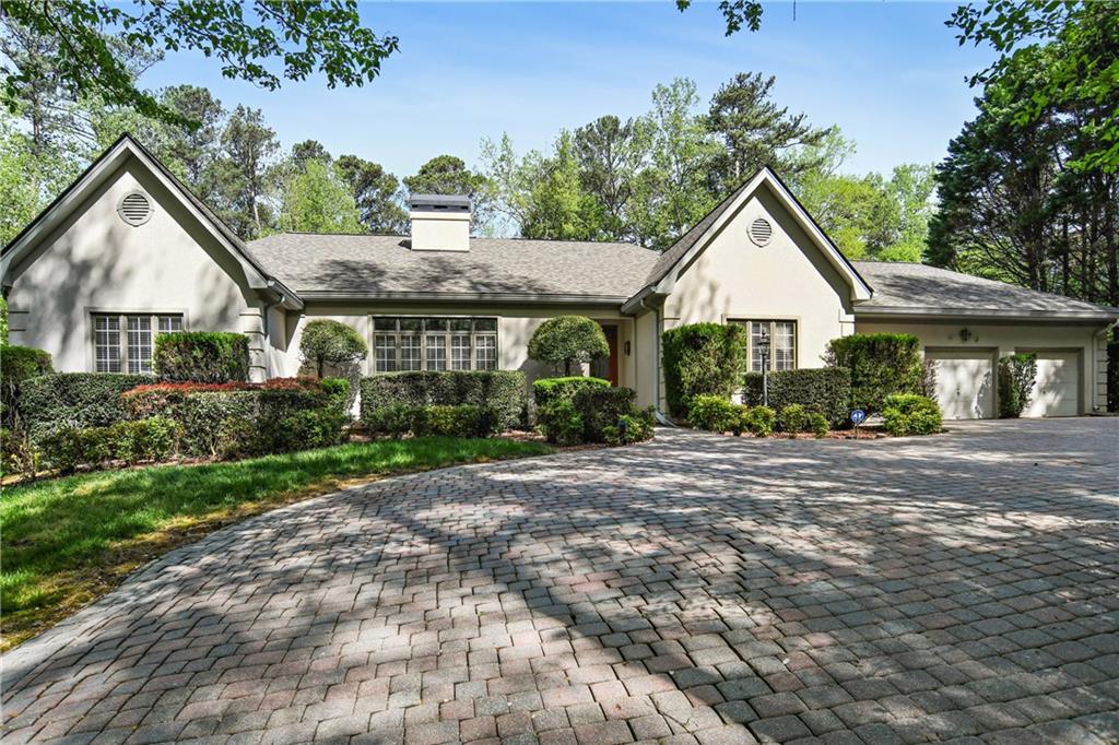 8960 Medlock Bridge Road Johns Creek, GA 30097 - Photo 1 of 1 a front view of a house with a garden