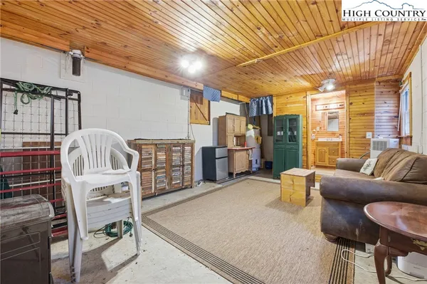 a living room with furniture a flat screen tv and a table