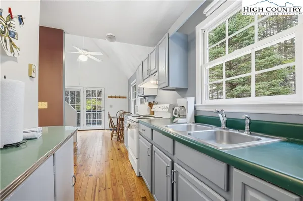 a kitchen with a sink stove and a large window