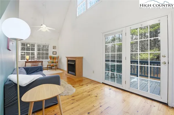 a view of a livingroom with furniture and a floor to ceiling window