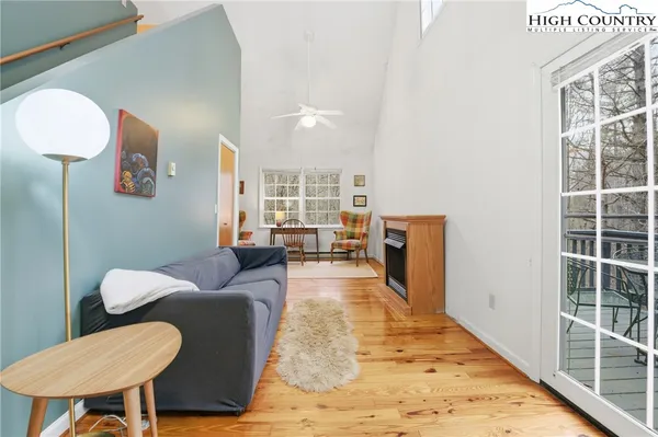 a living room with furniture and a floor to ceiling window