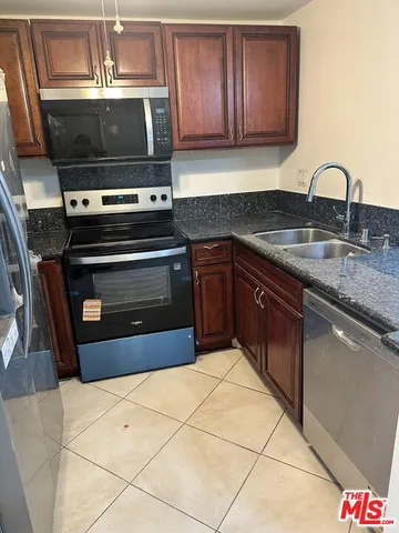 a kitchen with a sink and a stove top oven