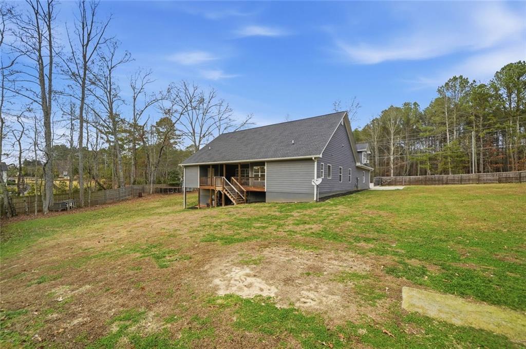 1006 Owens Store Road Canton, GA 30115 - Photo 33 of 48 a view of a house with backyard and trees