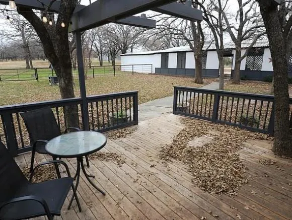 a view of a wooden chairs and table in the patio