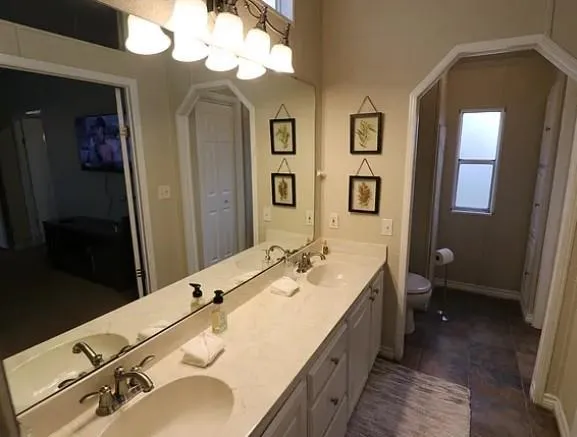 a spacious bathroom with a double vanity sink and a mirror