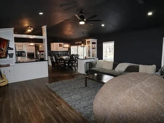 a living room with furniture and wooden floor