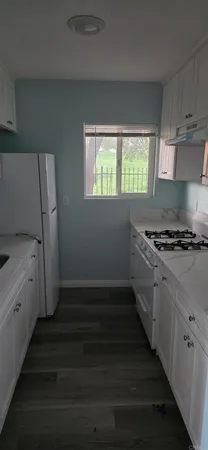 a kitchen with cabinets and window