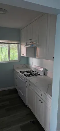 a stove top oven sitting inside of a kitchen
