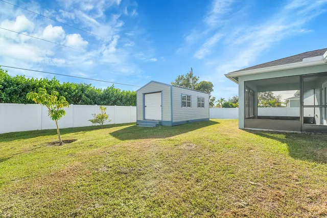 a view of an house with backyard space and balcony
