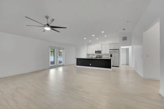 a view of a kitchen with a sink and a window