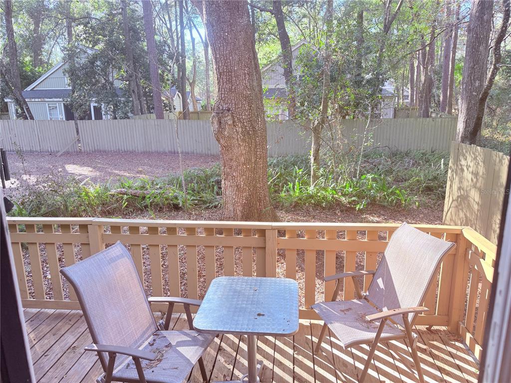 5134 Southwest 92nd Court Gainesville, FL 32608 - Photo 19 of 20 a view of a chair and table in the patio