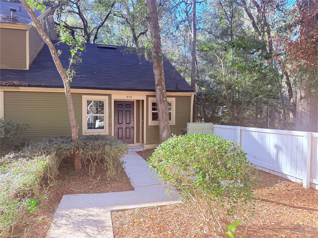 5134 Southwest 92nd Court Gainesville, FL 32608 - Photo 3 of 20 a front view of a house with garden