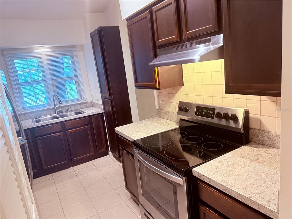 5134 Southwest 92nd Court Gainesville, FL 32608 - Photo 8 of 20 a kitchen with a stove and a microwave