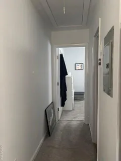 a view of a hallway with closet and wooden floor