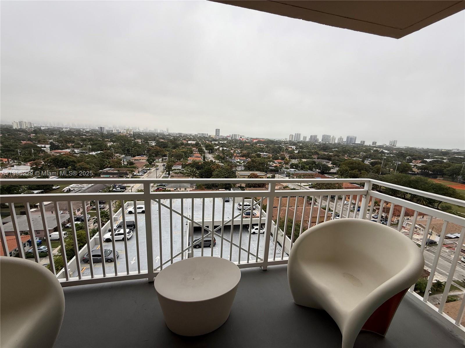 2665 Southwest 37th Avenue, Unit 1213 Miami, FL 33133 - Photo 19 of 54 a roof deck with a table and chairs