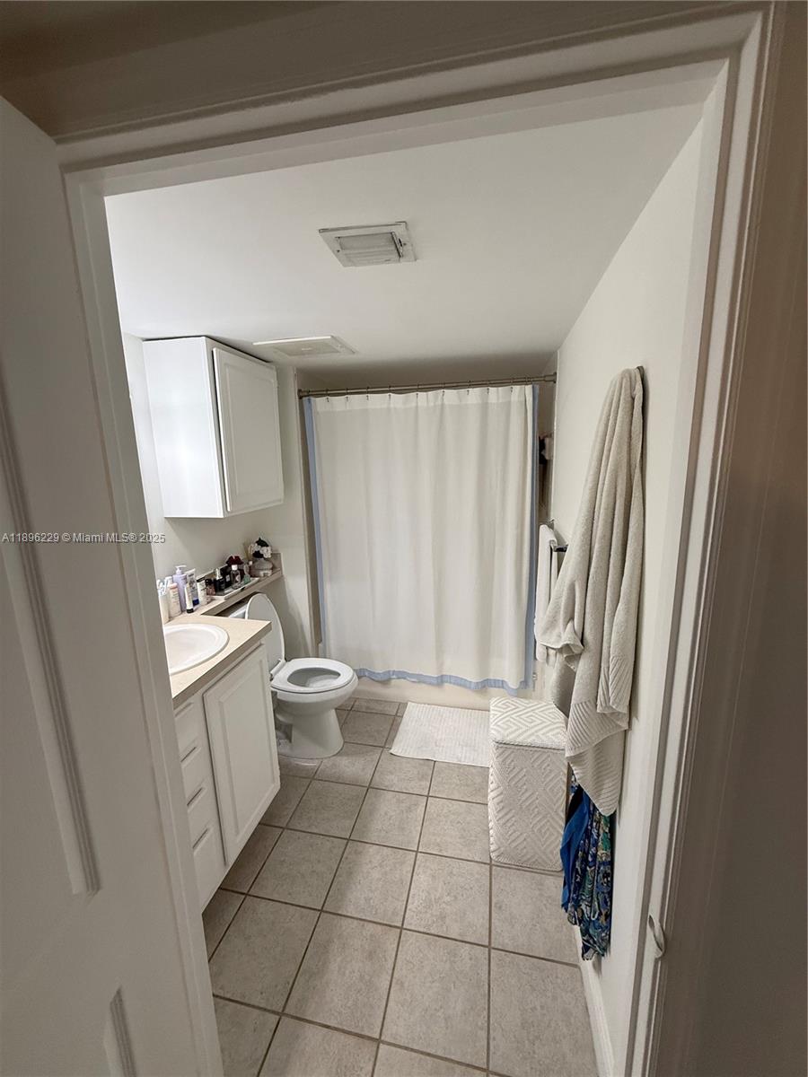 2665 Southwest 37th Avenue, Unit 1213 Miami, FL 33133 - Photo 26 of 54 a bathroom with a sink a toilet and a shower