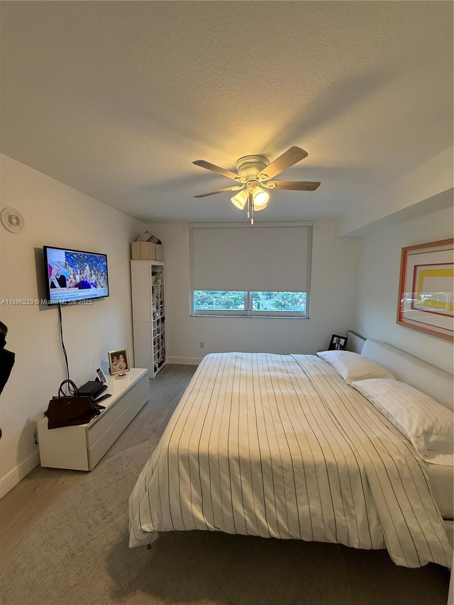 2665 Southwest 37th Avenue, Unit 1213 Miami, FL 33133 - Photo 29 of 54 a bedroom with a bed and a chandelier