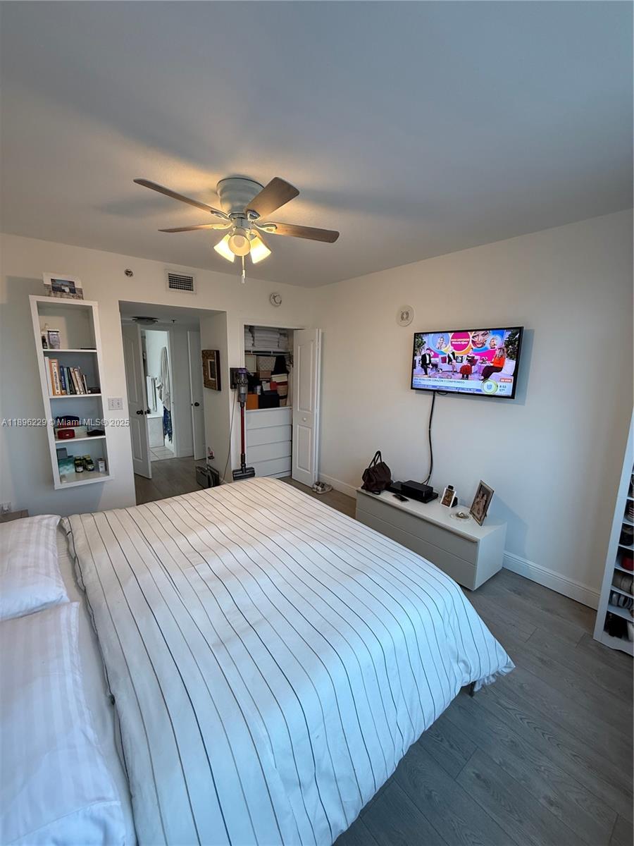 2665 Southwest 37th Avenue, Unit 1213 Miami, FL 33133 - Photo 34 of 54 a bedroom with bed and a chandelier