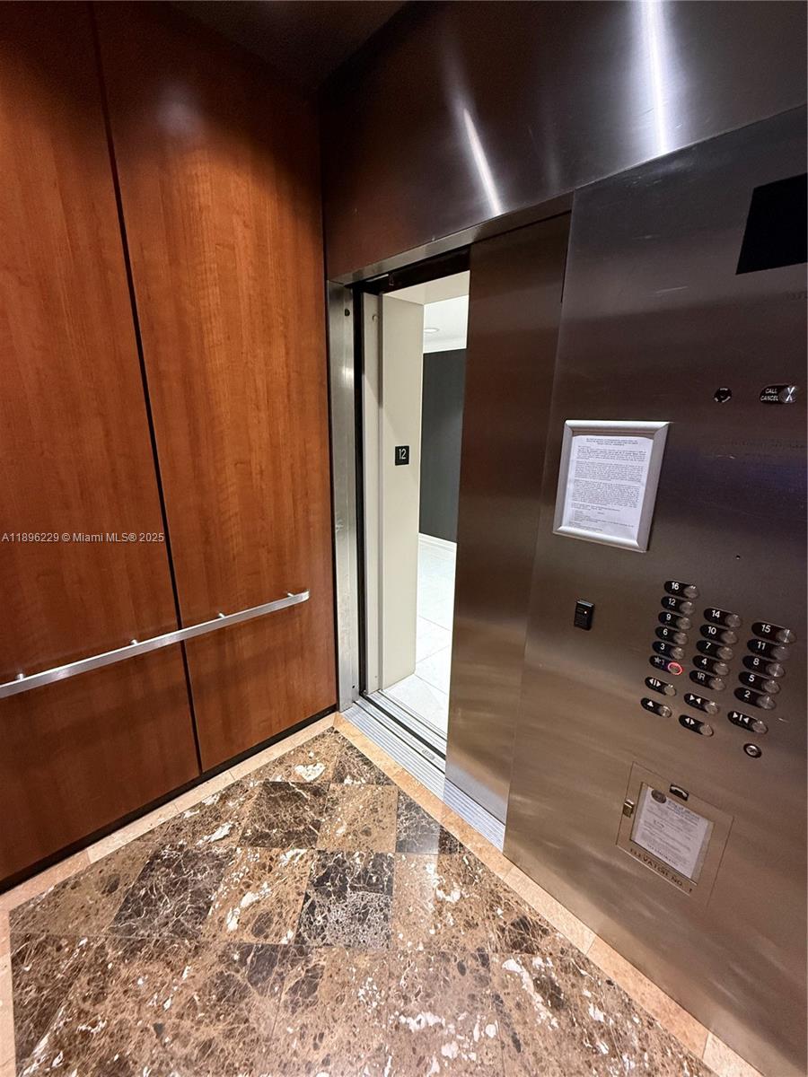 2665 Southwest 37th Avenue, Unit 1213 Miami, FL 33133 - Photo 38 of 54 a view of a hallway with a large window