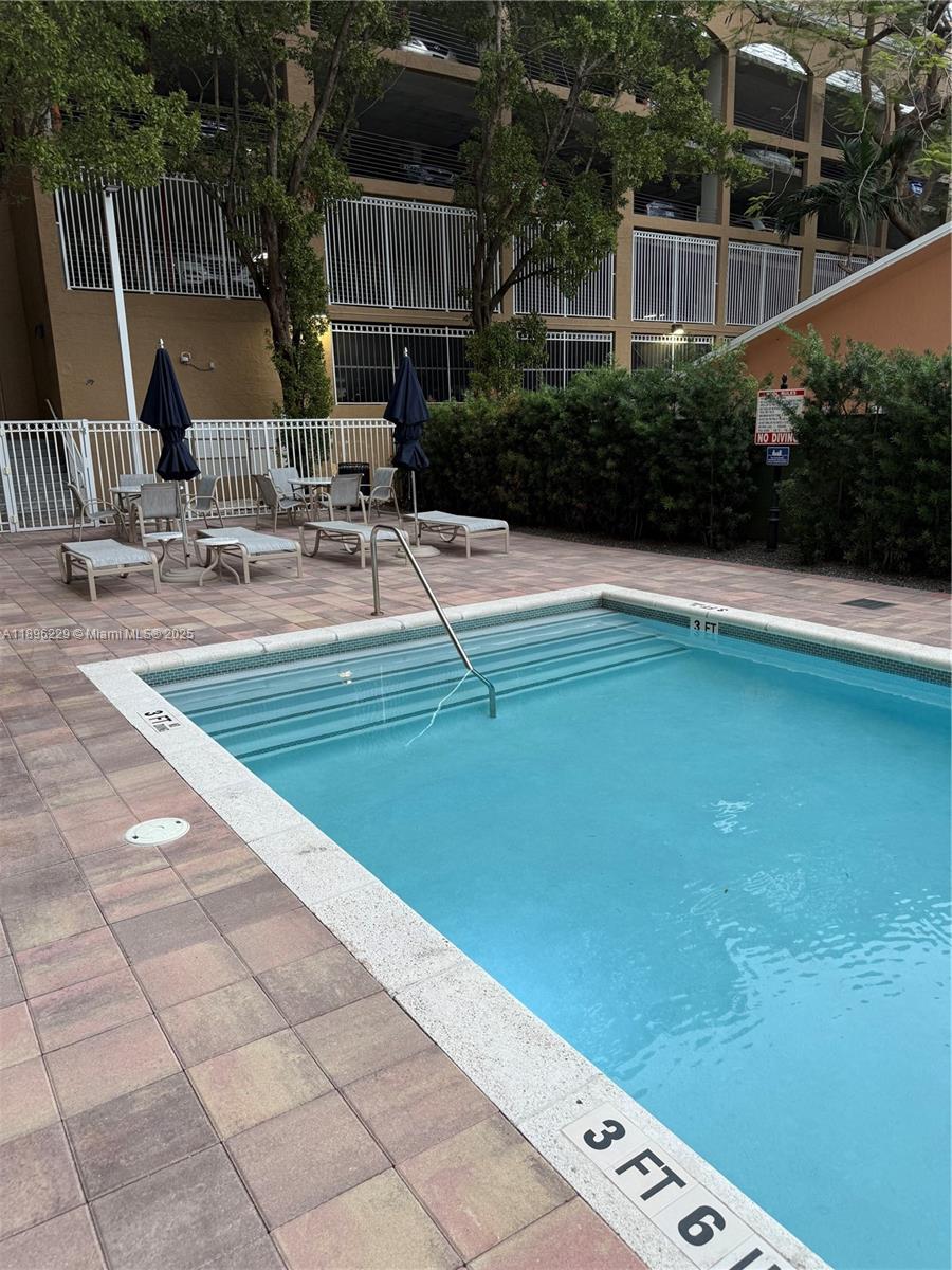 2665 Southwest 37th Avenue, Unit 1213 Miami, FL 33133 - Photo 44 of 54 a view of swimming pool with outdoor seating and plants