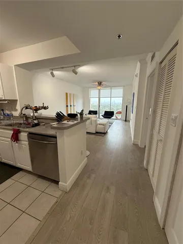 a room with a washing machine and a refrigerator