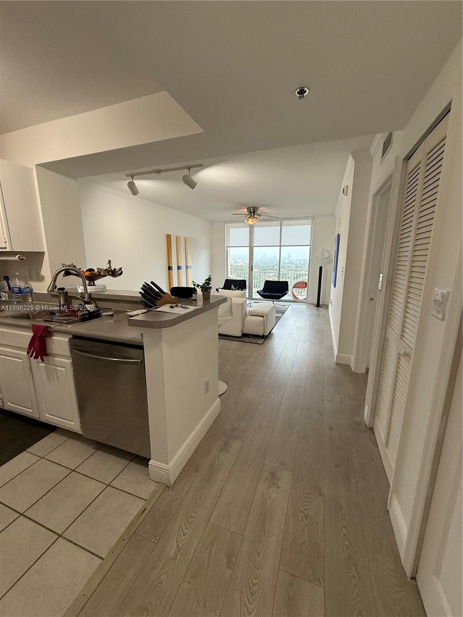 2665 Southwest 37th Avenue, Unit 1213 Miami, FL 33133 - Photo 7 of 54 a kitchen with a sink a stove a refrigerator and cabinets