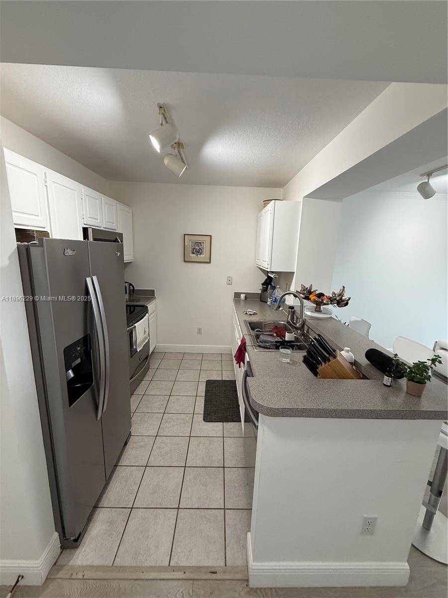 2665 Southwest 37th Avenue, Unit 1213 Miami, FL 33133 - Photo 8 of 54 a room with a washing machine and a refrigerator