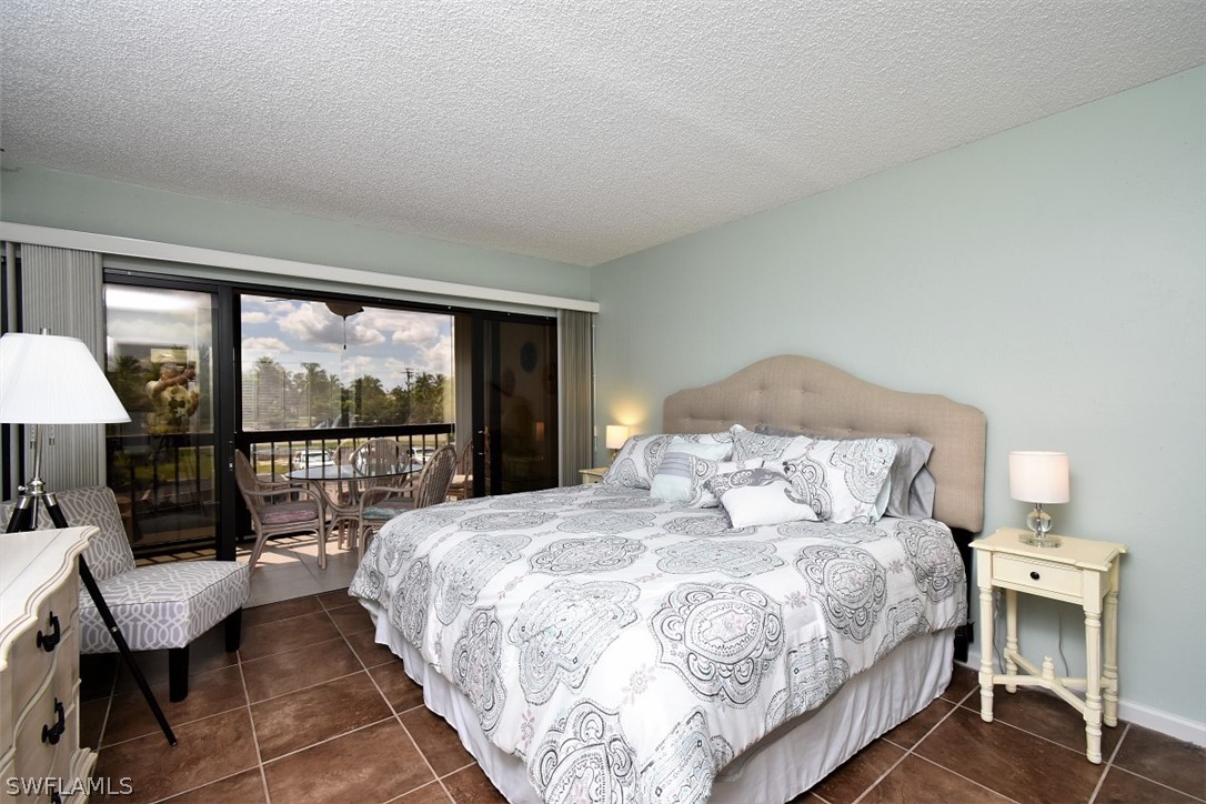 3170 Matecumbe Key Road, Unit 123 Punta Gorda, FL 33955 - Photo 13 of 25 a bedroom with a bed and a large window