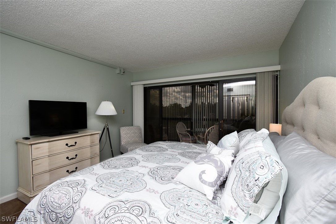 3170 Matecumbe Key Road, Unit 123 Punta Gorda, FL 33955 - Photo 14 of 25 a bedroom with a bed and a flat screen tv