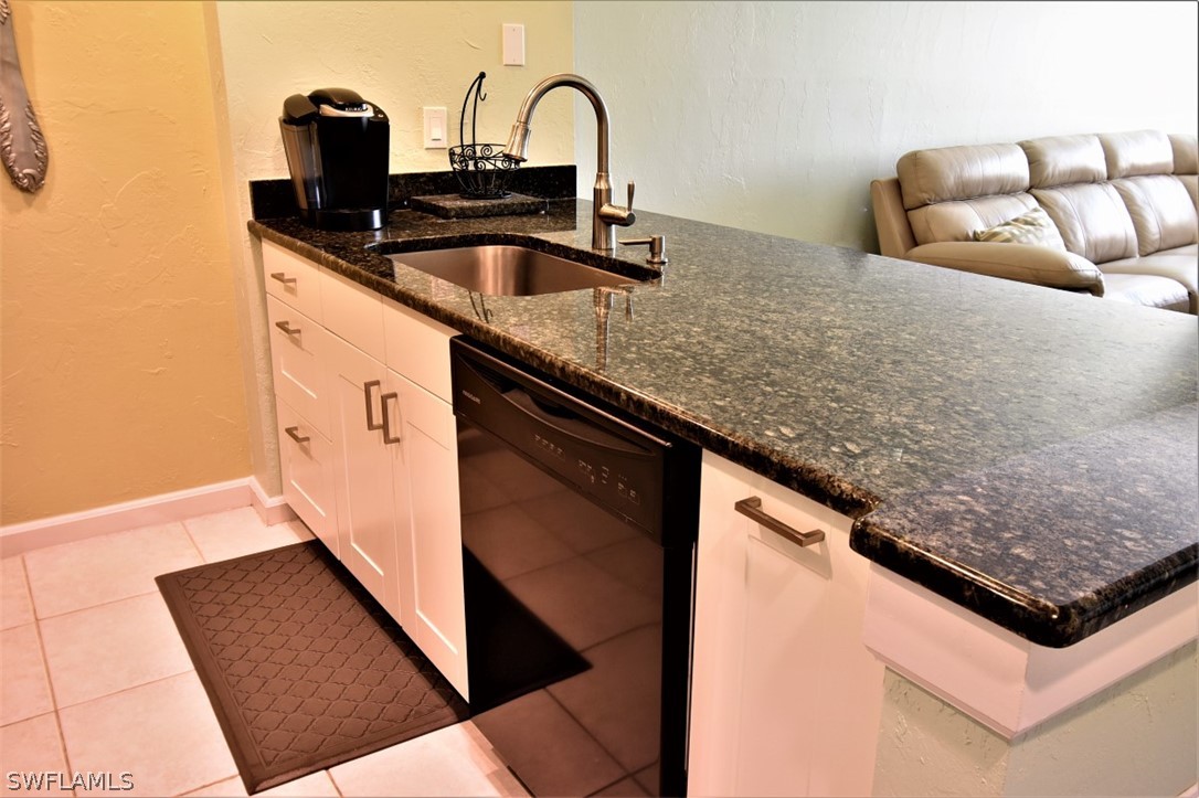 3170 Matecumbe Key Road, Unit 123 Punta Gorda, FL 33955 - Photo 5 of 25 a kitchen with granite countertop a sink and a stove