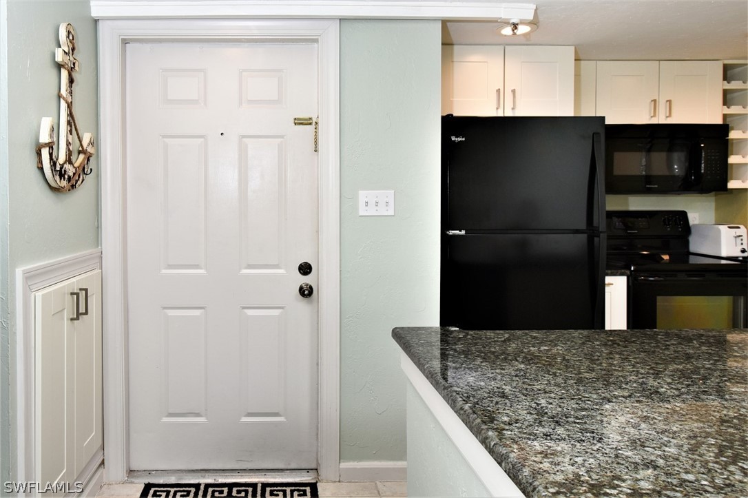 3170 Matecumbe Key Road, Unit 123 Punta Gorda, FL 33955 - Photo 7 of 25 a kitchen with stainless steel appliances granite countertop a refrigerator and a sink